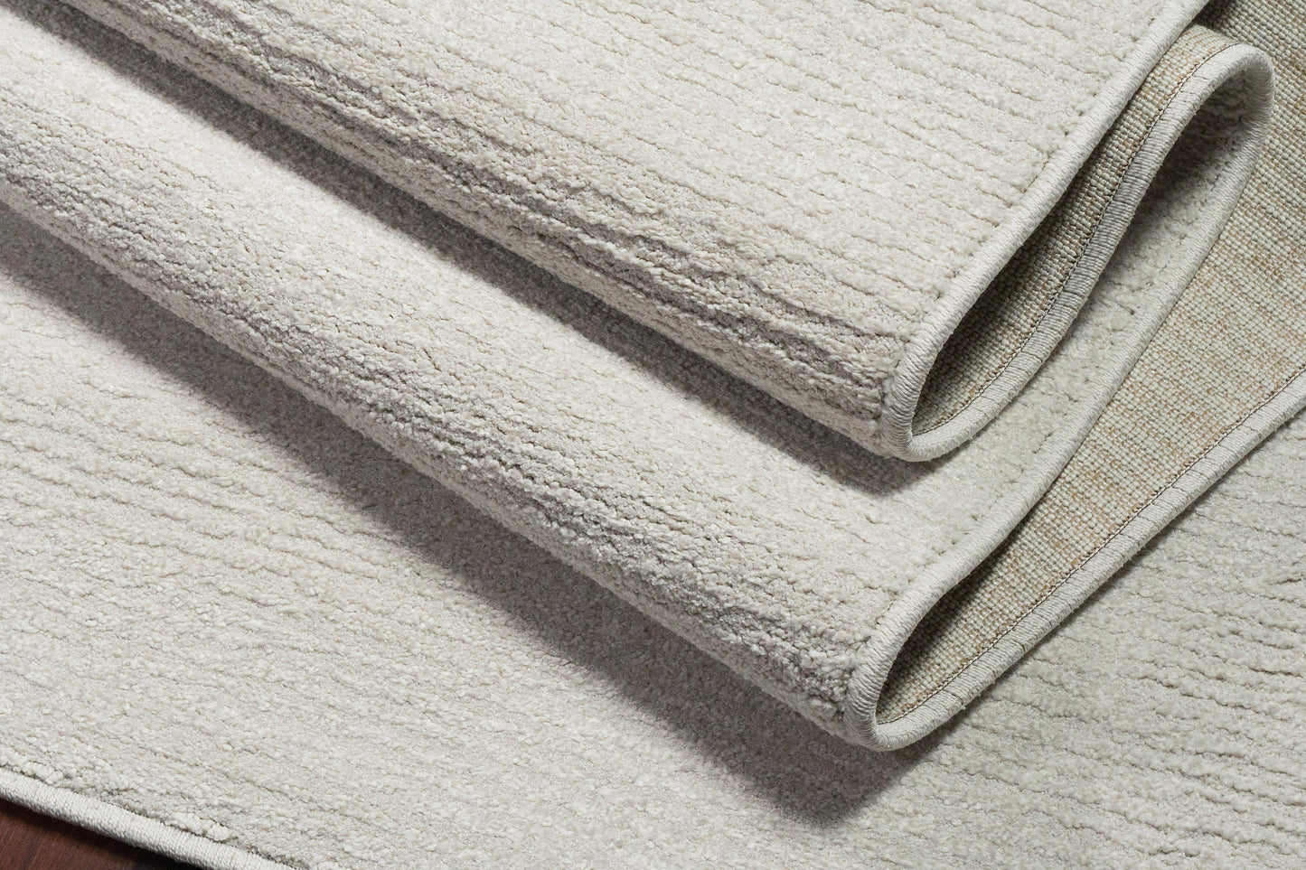 Quin Solid Ivory Solid Color High-Low Rug
