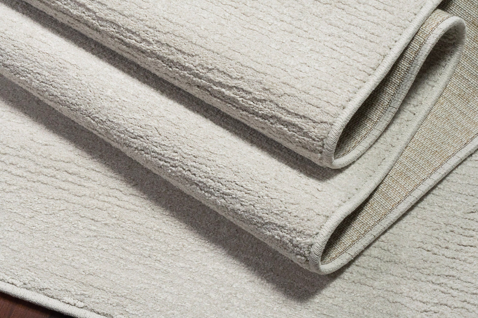 Quin Solid Ivory Solid Color High-Low Rug