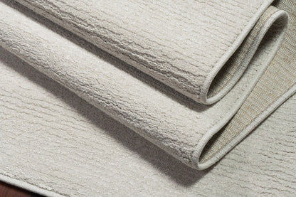 Quin Solid Ivory Solid Color High-Low Rug