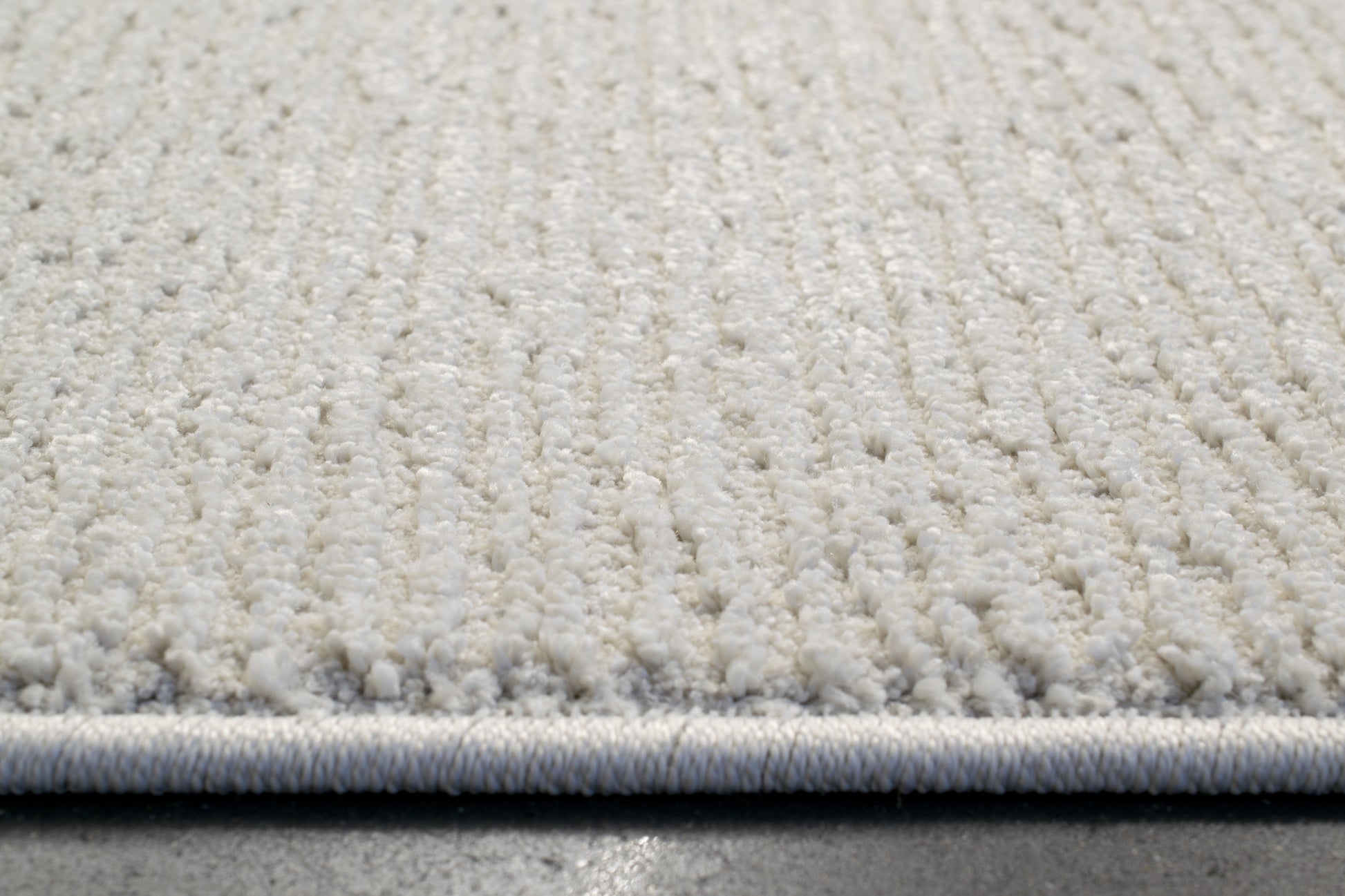 Quin Solid Ivory Solid Color High-Low Rug